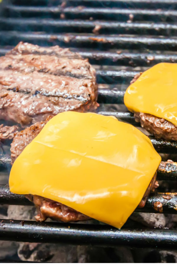 putting cheese on best homemade grilled hamburgers 