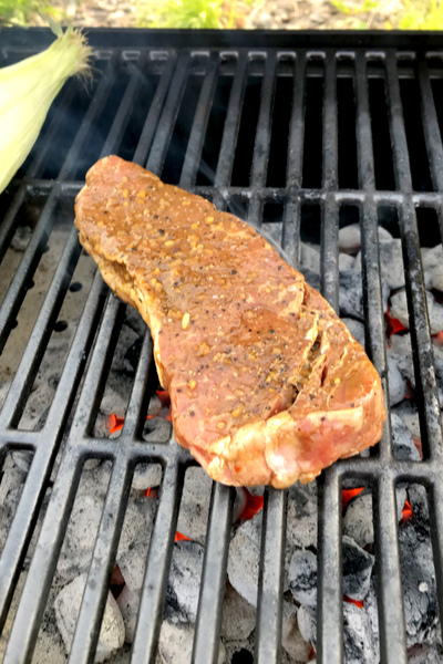 raw steak on the grill