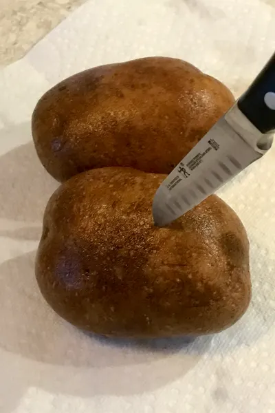 knife piercing a potato