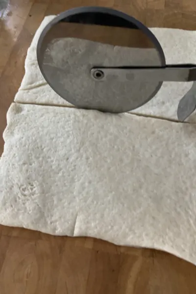 cutting pizza dough