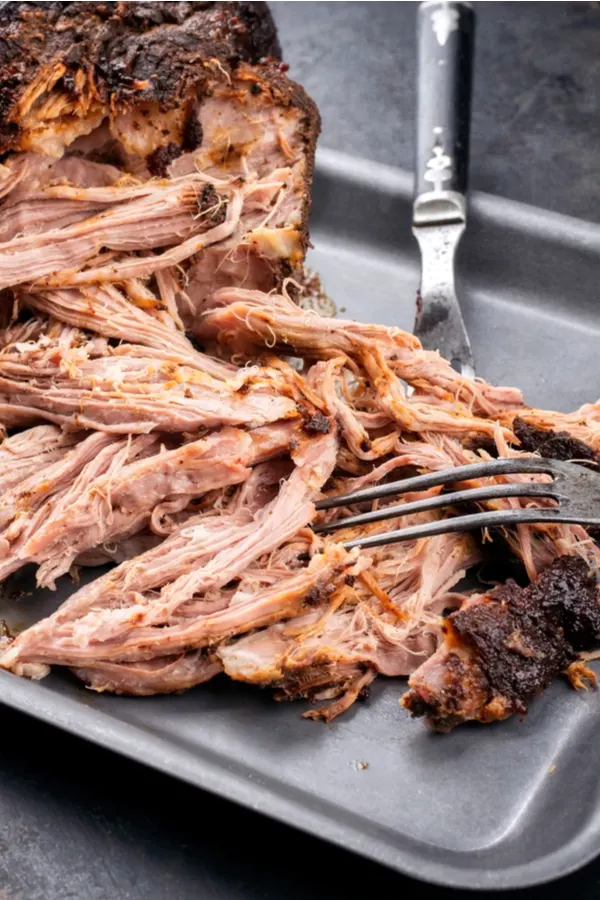meat pulled apart with two forks 