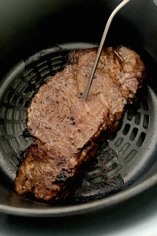 digital thermometer in steak 