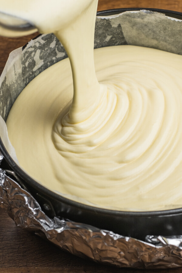 Bailey's Irish Cream Cheesecake batter being poured in a springform pan