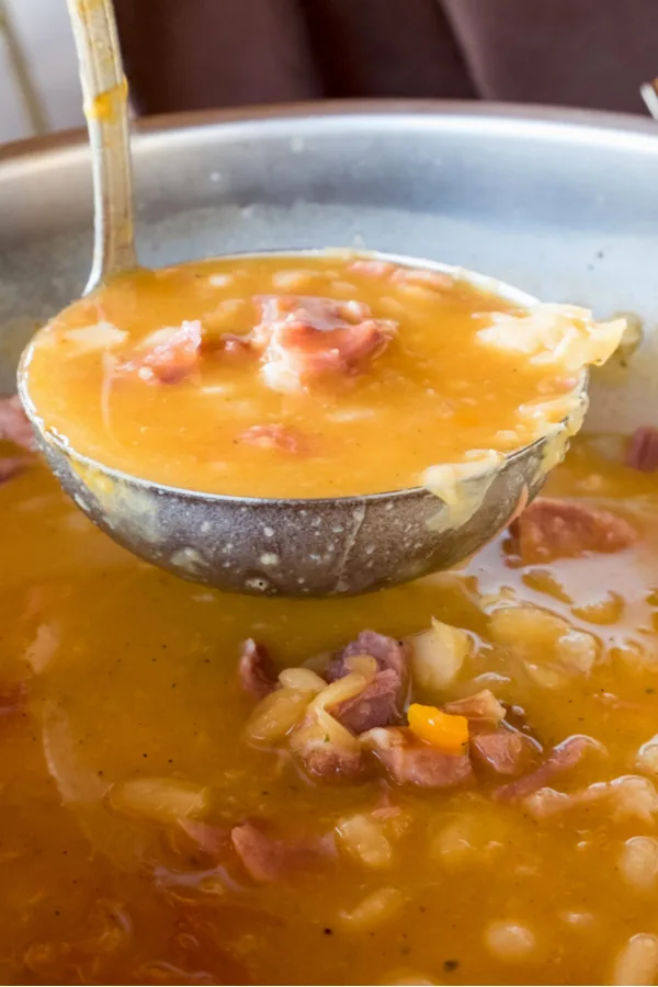 ladle of instant pot ham and bean soup