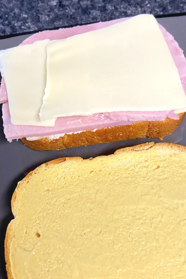 cheese on top of ham on top of bread