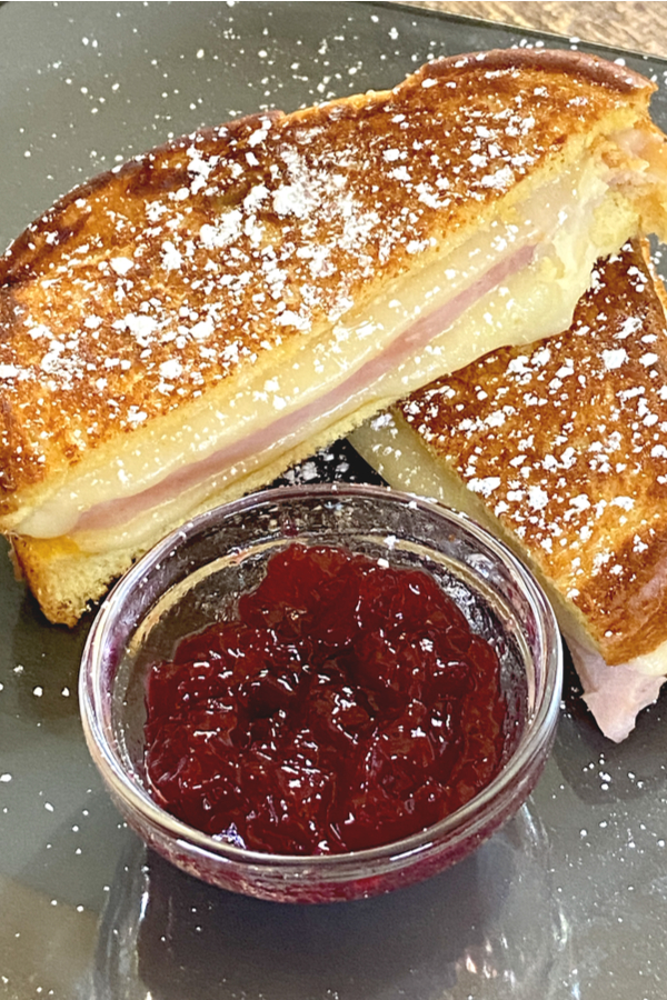 monte cristo sandwich cut in half served with raspberry jam