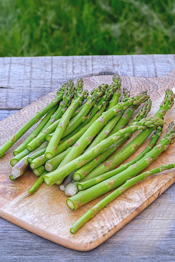 asparagus spears of all different thickness on cutting board