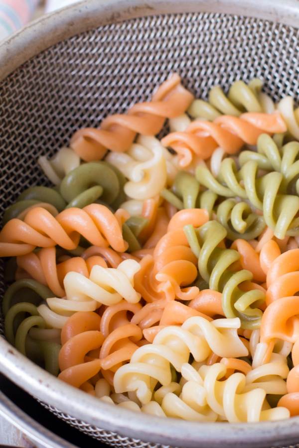 tri color rotini pasta draining 