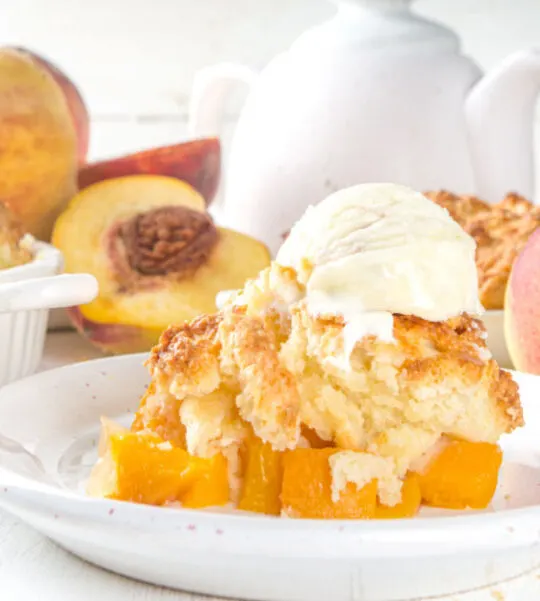 peach cobbler with vanilla ice cream on top