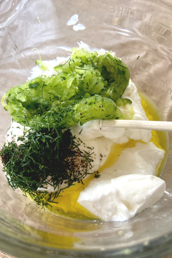 Greek Yogurt, fresh dill and grated cucumber in a mixing bowl