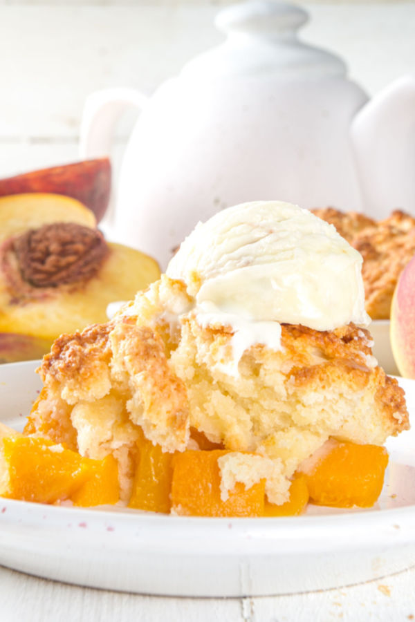 classic peach cobbler with ice cream on top
