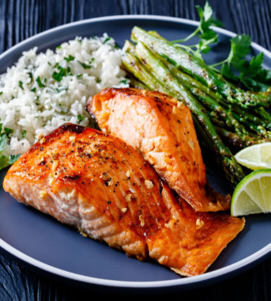 best air fryer salmon on plate with rice and asparagus