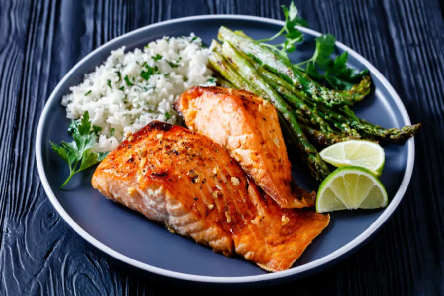 best air fryer salmon on plate with rice and asparagus