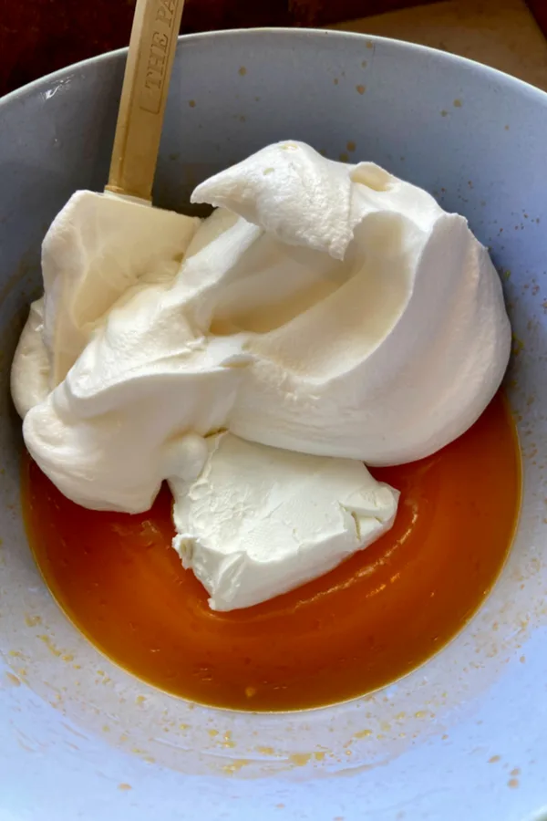 cream cheese and cool whip added to orange jello 
