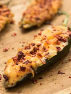 baked jalapeno poppers on wooden tray