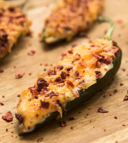 baked jalapeno poppers on wooden tray