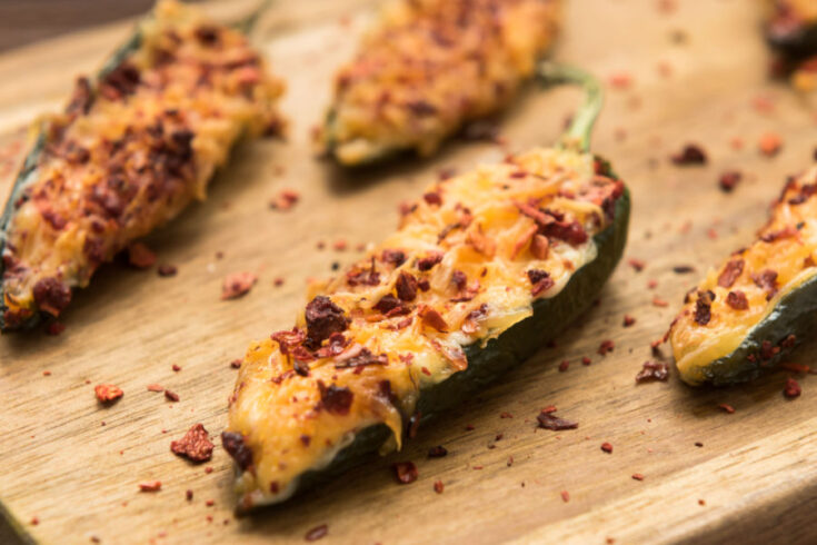 baked jalapeno poppers on wooden tray