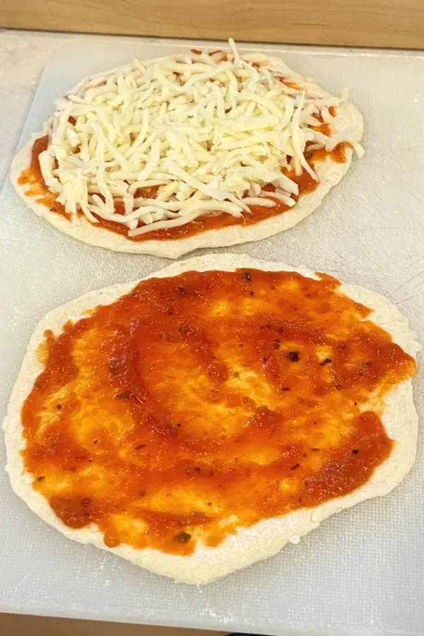 biscuit dough mini pizza with sauce and cheese