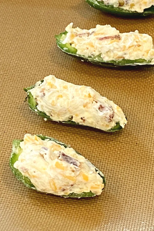 cream cheese filling in halves of jalapeno peppers 