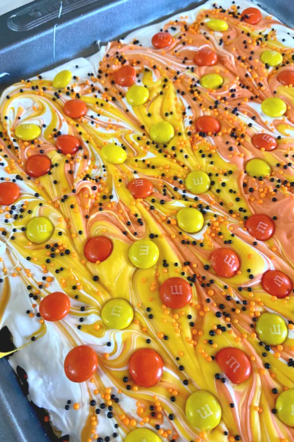 candy coated chocolates on top of Halloween candy bark