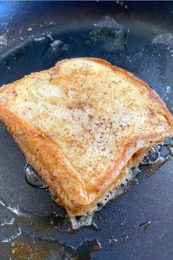 cooking Texas Toast in a skillet 