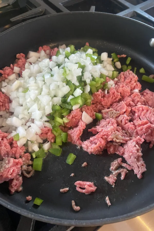 ground beef diced onions and green peppers in skillet 