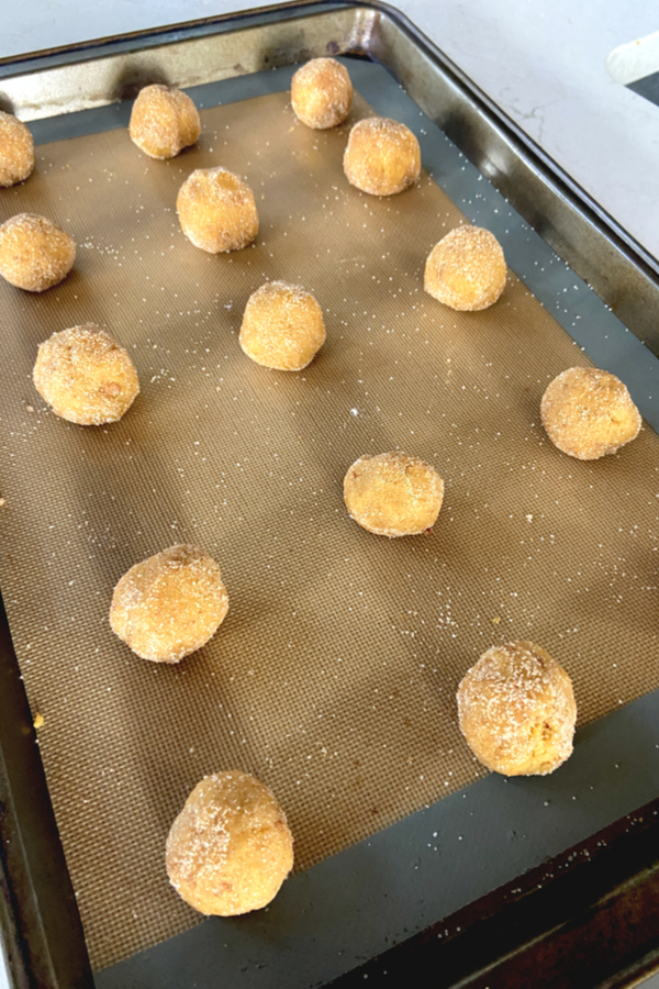 cookie dough balls on silicone baking mat