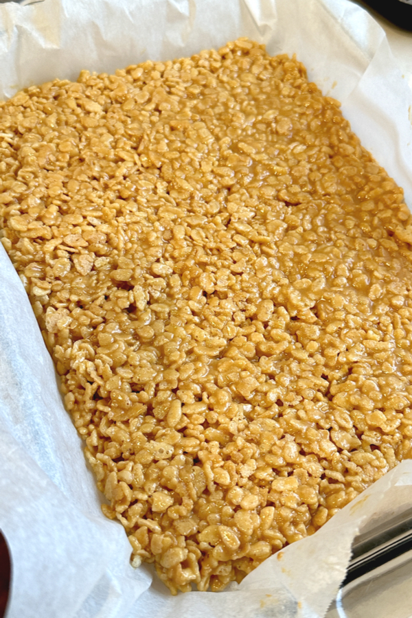 Peanut butter rice krispies spread in a baking dish 