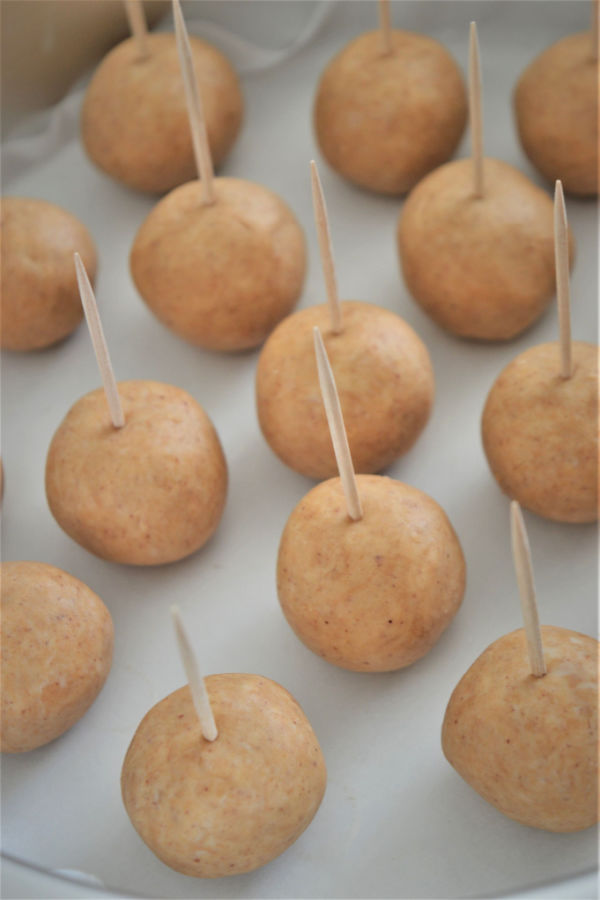 peanut butter balls with toothpick in the top
