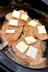 butter and seasoning on chicken