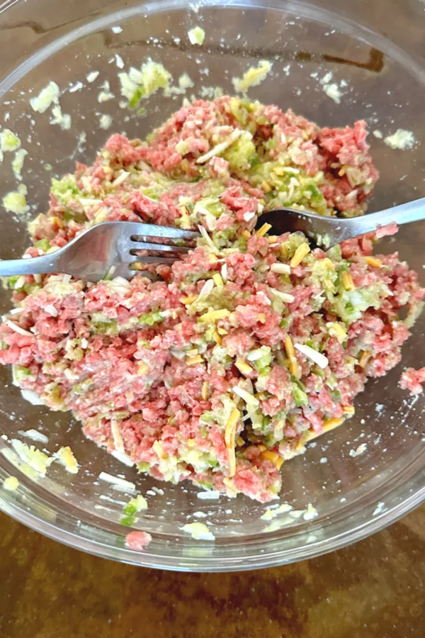 mixing meatloaf ingredients with two forks