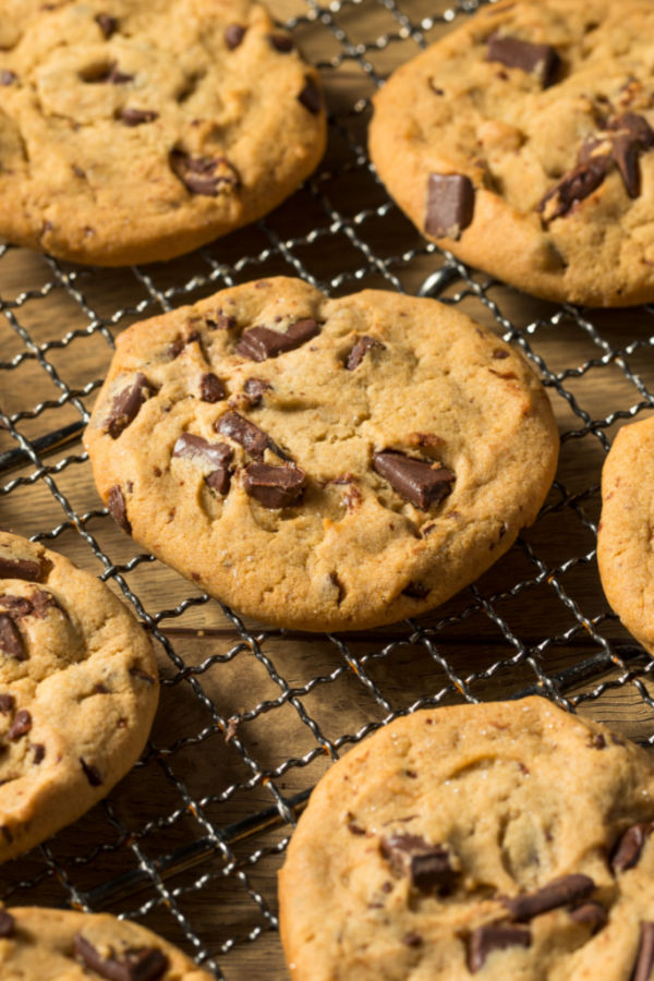 Chocolate chip cookies on a baking rack that are made with an egg substitute
