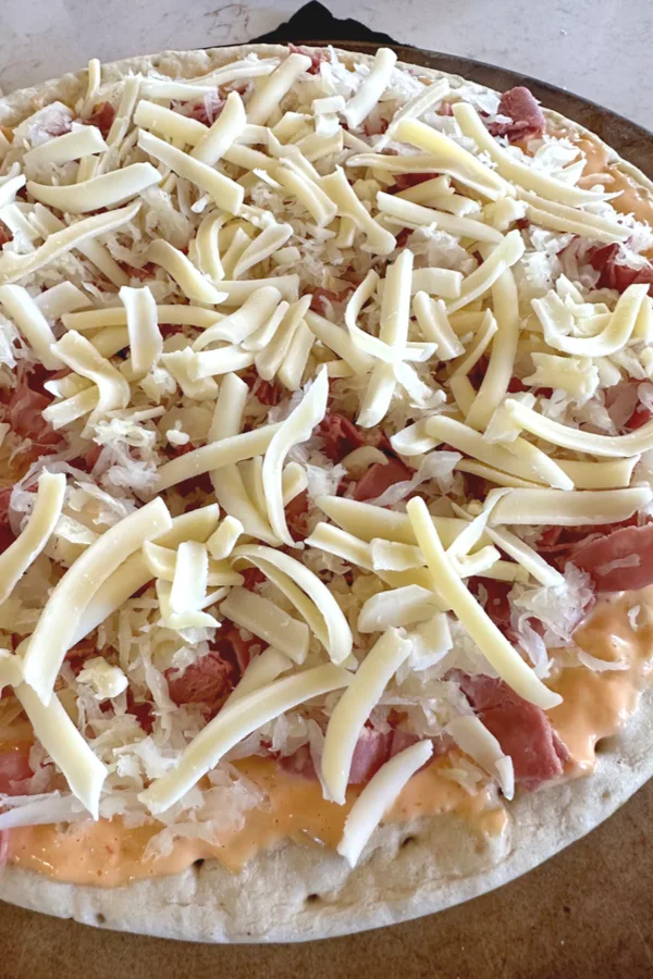fresh grated Swiss cheese on pizza