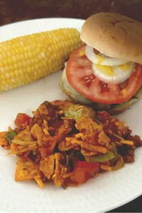 Doritos taco salad with hamburger and corn on the cob