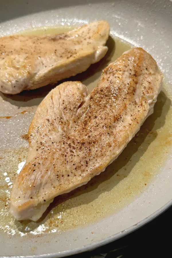 browning chicken breasts in a skillet 