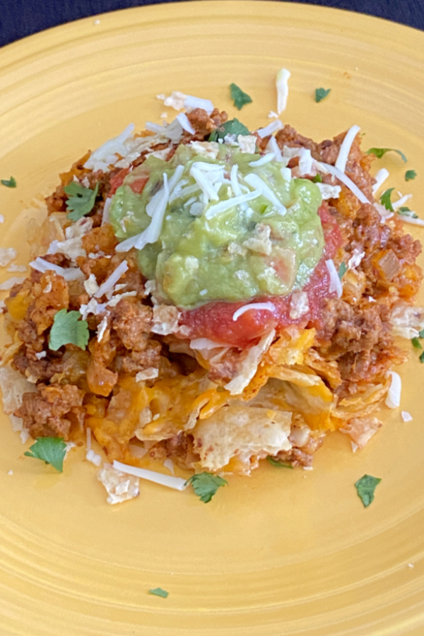 easy taco casserole topped with guacamole