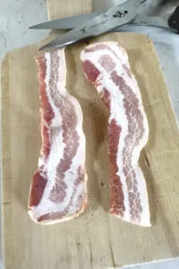 cutting bacon in half with scissors