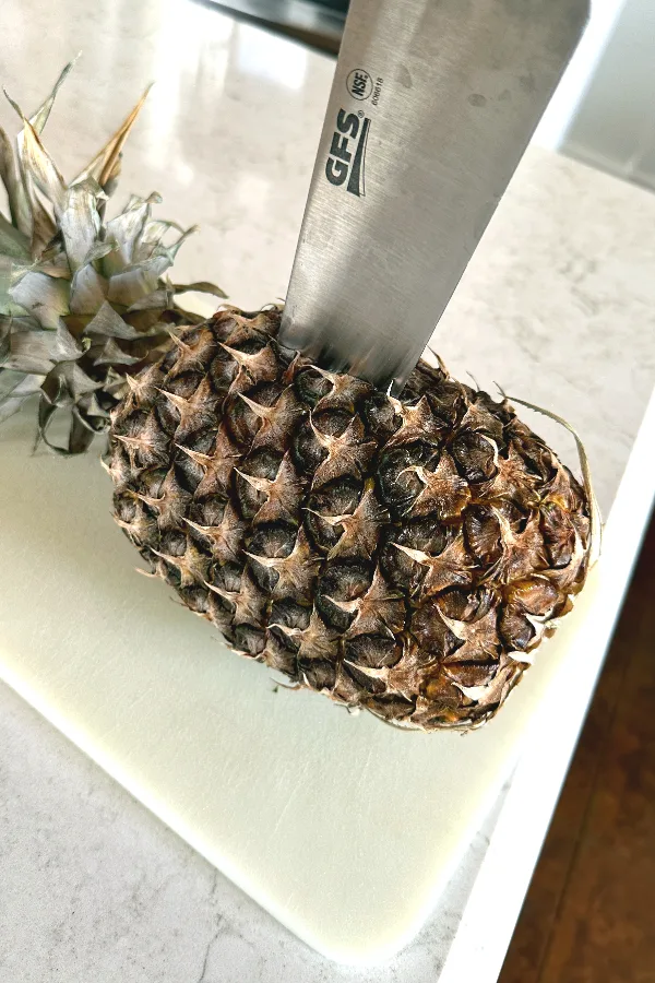 cutting a pineapple in half 