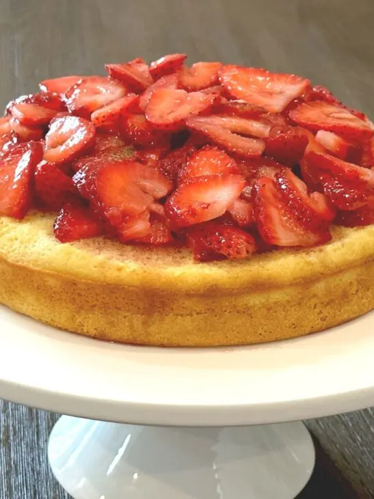 strawberry shortcake on white cake pedestal