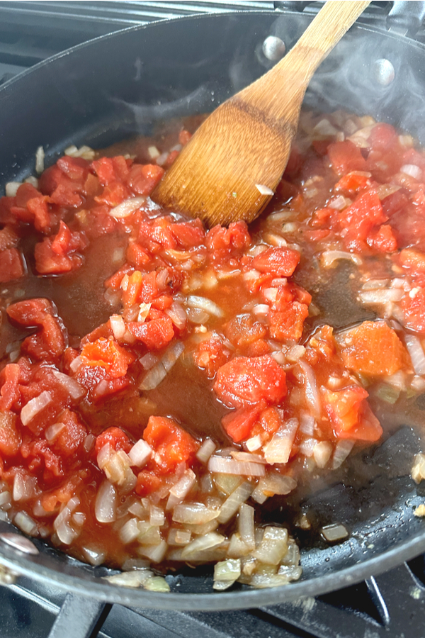 tomatoes and onions in skillet 
