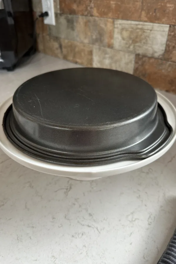 cake pan flipped upside down on a platter