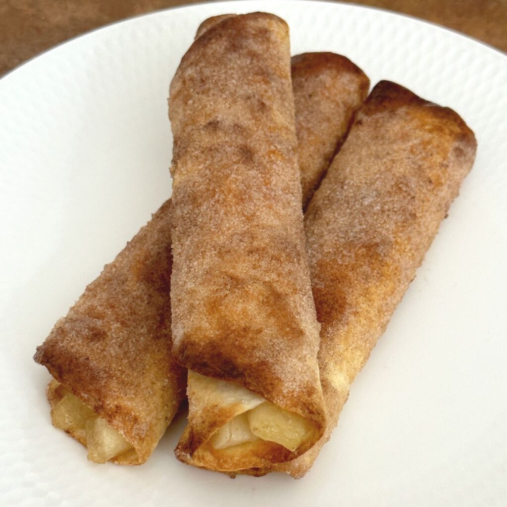 air fryer apple pie roll ups on white plate