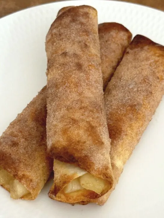 air fryer apple pie roll ups on white plate