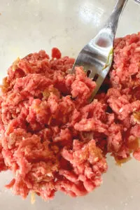 mixing ground beef to flavor burger bites
