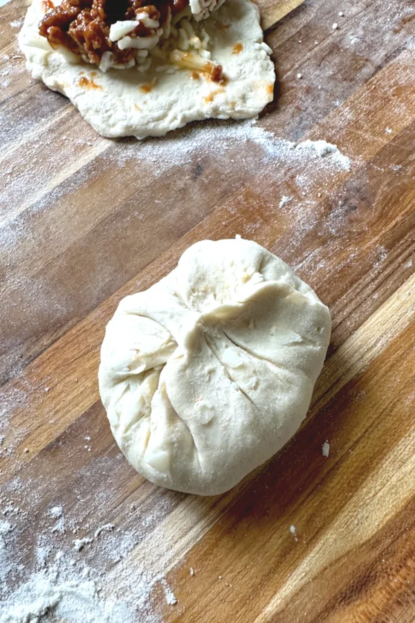 biscuit dough pinched together to make a ball 