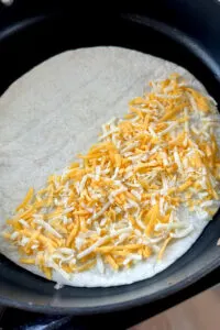 cheese on half of tortilla shell