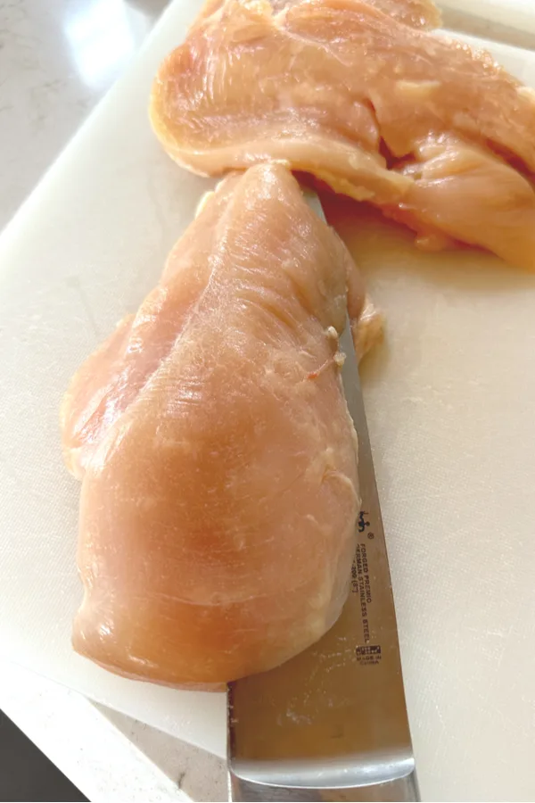 cutting chicken breast in half