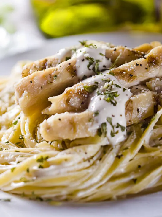 chicken fettuccine Alfredo served on a white plate