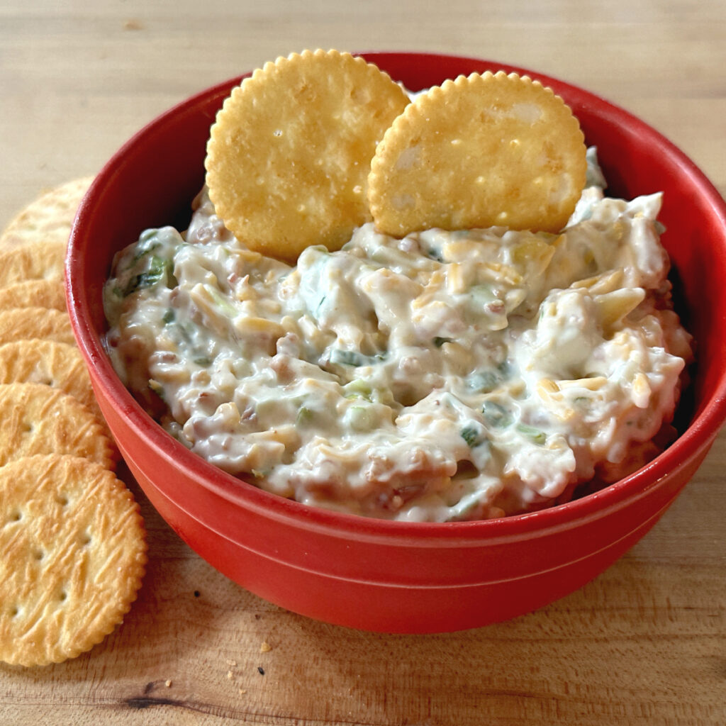 million dollar dip in red bowl with crackers 