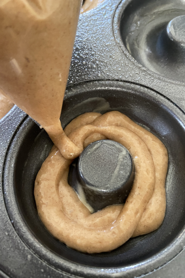 piping batter in a donut pan